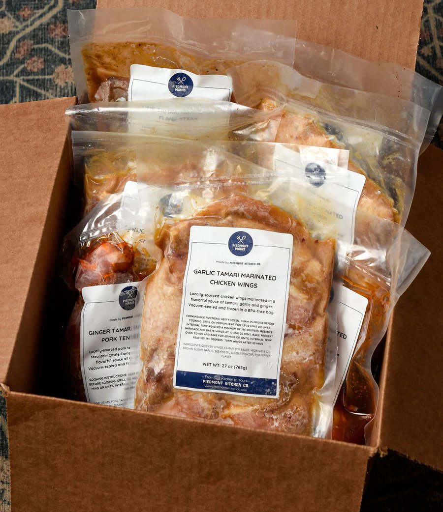 A box of vacuum sealed Piedmont BBQ meals ready to hand out